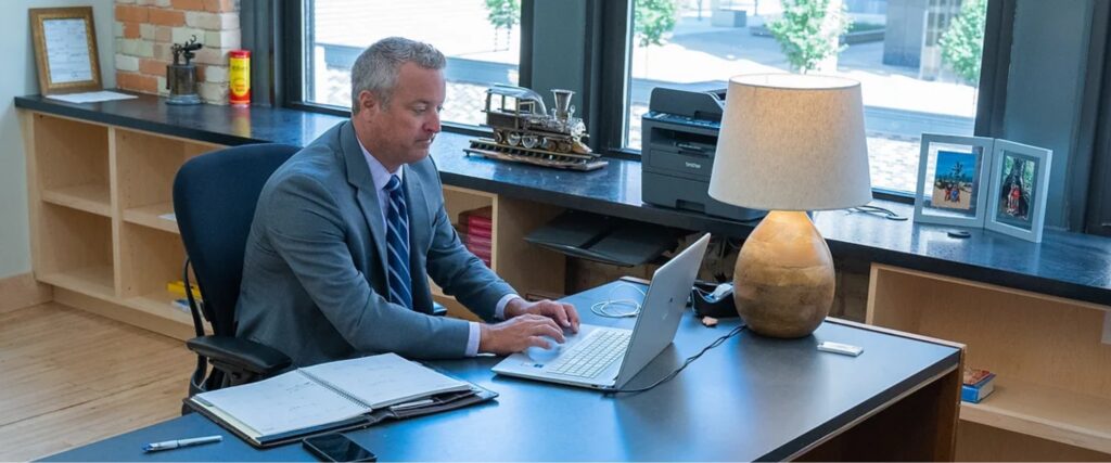 Attorney Mark Caldwell sitting at his desk in his Grand Rapids, MI office.