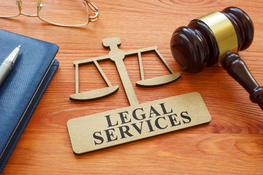 A Legal Services decorative header featuring a justice scale, gavel and legal binder.