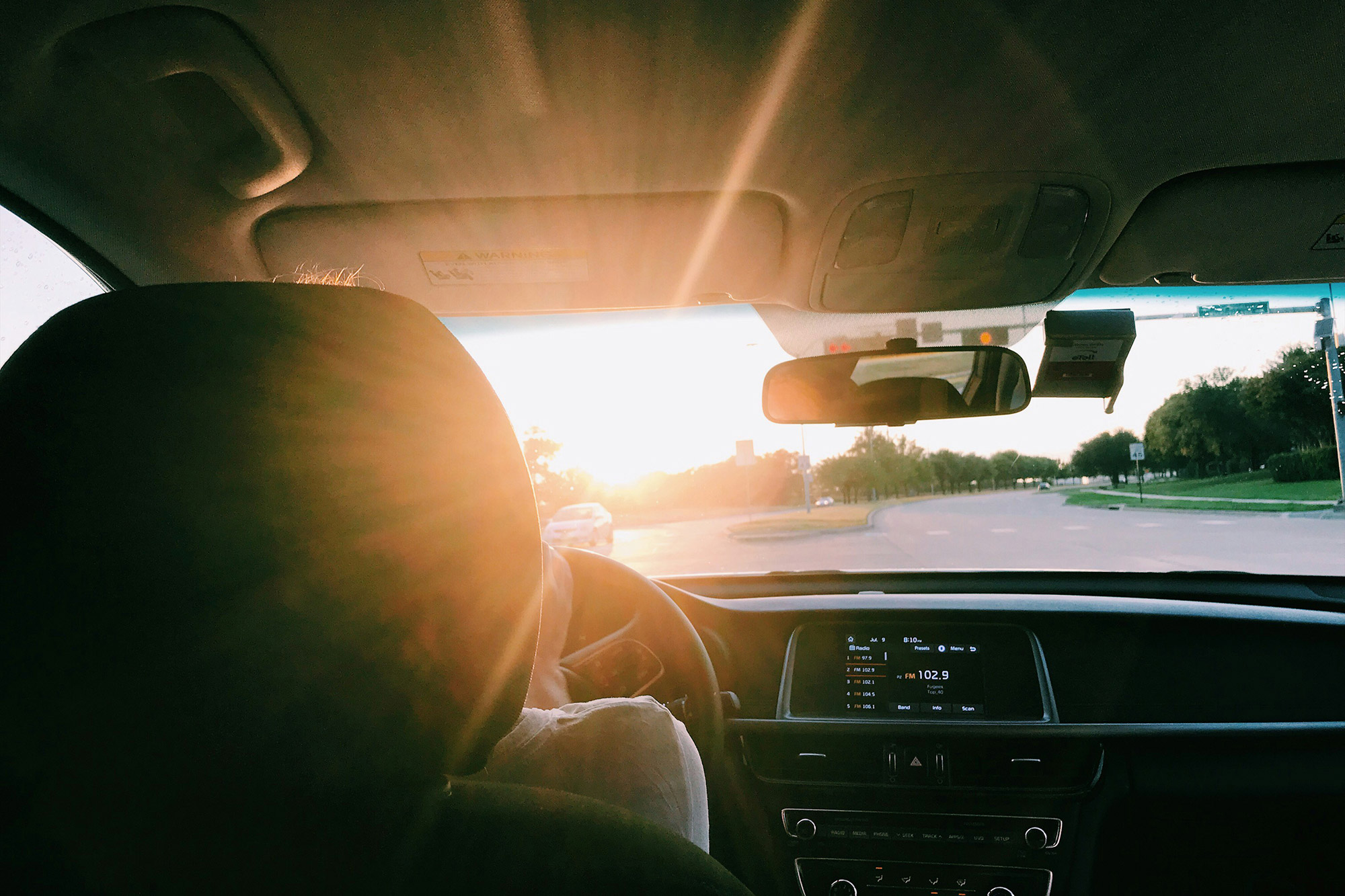 A view from the backseat of a passenger vehicle - representing someone who has lost their license and needs to go through the driver's license restoration process.