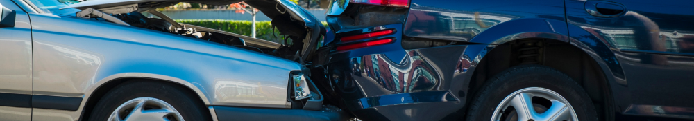 A closeup view of two cars in a drunk driving accident.