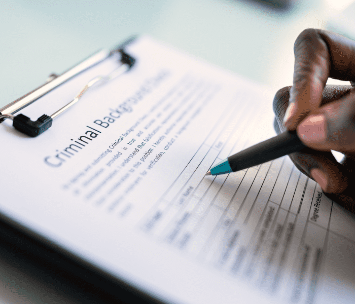 What does criminal record expungement mean A person applying for a job fills out a criminal background check form.